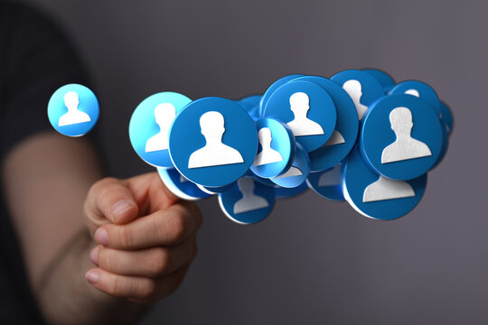 A hand holding a collection of profile icons, symbolizing community, connection, networking, and social media. This image is ideal for concepts