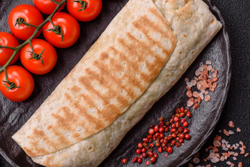 Shawarma with chicken or beef, tortilla roll, and vegetables. Shawarma with meat