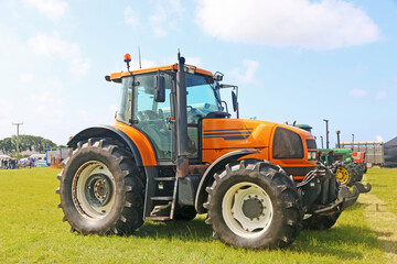Obraz premium Vintage tractors standing in a field