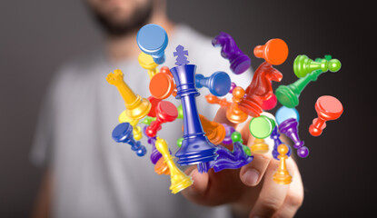 Hand manipulating colorful chess pieces. Concept of strategy, leadership, competition, and planning...