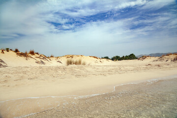 Sandy beach of Pounta, in the southernmost part of the Laconia peninsula, in Peloponnese region, Greece, Europe, during an overcast day with white clouds over blue sky. 