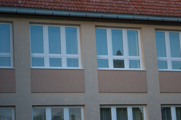 Modern apartment windows with patterned curtains
