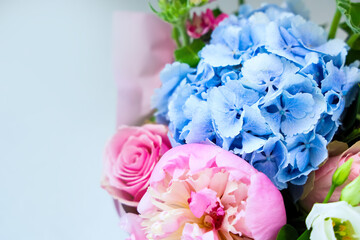 Bright flower bouquet with blue hydrangeas and pink roses arranged for a special occasion