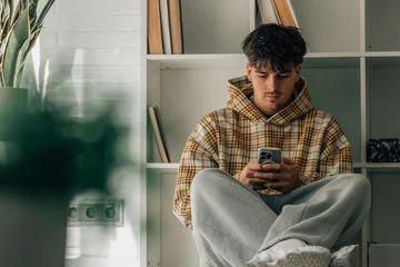 Fototapete Rund Musik teenager at home with cell phone sitting on the floor  © carballo