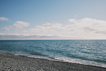 Obraz premium Wide seascape with calm blue water and clouds above the Black Sea horizon, Russia