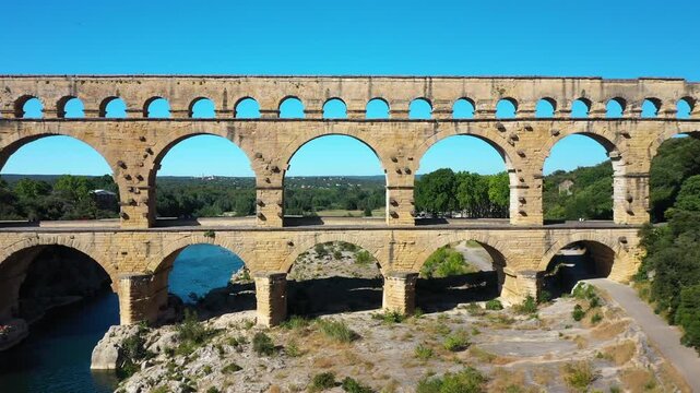 The Pont du Gard is an ancient Roman aqueduct, that is depicted  on five euro note. Summertime.