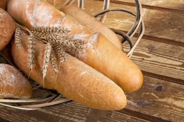 Pieces of tasty fresh bread on wooden table
