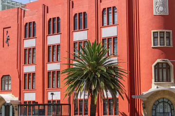 Art Deco Building with Palm Trees in Mexico City – Vibrant Red Facade, Tropical Modernism, and Architectural Detail in Urban Latin American Heritage and Design Photography