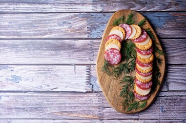 Salami sausage and cheese slices and crackers in the form of Christmas stick for Christmas holidays