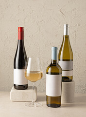 various wine bottles and glass of white wine