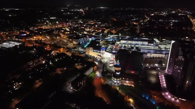 An aerial night capture of Basingstoke Town centre with Festival Place shopping centre, retail facilities , commercial and residential buildings.