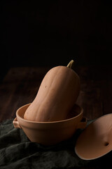 Fresh Homegrown Butternut Squash in a wide bowl against dark moody background.
