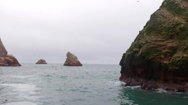 A view of the bird-filled cliffs of Paracas National Park from the ocean