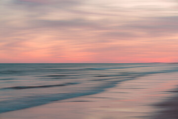 Dreamy seascape in pink evening light