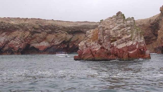 A view of the bird-filled cliffs of Paracas National Park from the ocean