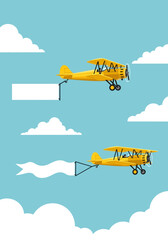 Two yellow biplanes flying with blank advertising banners. © MilioDerestd.co