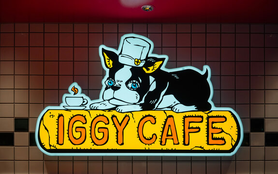 tokyo, shibuya - sep 12 2025: Bright neon sign of iGGY CAFE at the official shop THE JOJO WORLD featuring the boston terrier dog from Japanese manga Jojo&rsquo;s Bizarre Adventure create by Hirohiko Araki.
