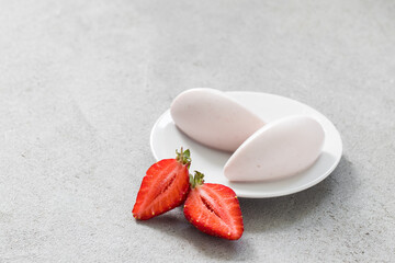 Vanilla strawberry cream quenelle. On a plate. Close-up	
