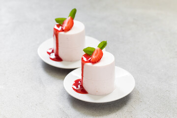 Vegan Strawberry cream pudding, Panna Cotta cylindrical shape. With sauce. Close up