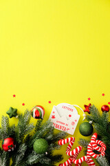 Christmas bottom border with Santa letter envelope, pine branch, candy cane and bauble on yellow...