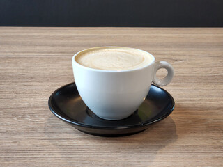 Fototapeta premium Brewed coffee in a porcelain cup. Hot coffee drink