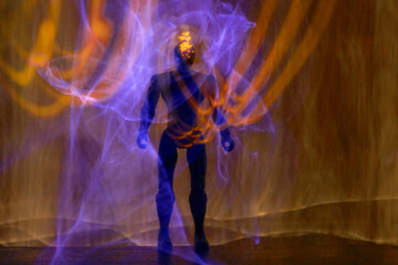 Mysterious humanoid figure emerging from glowing purple and orange energy waves
