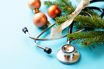 Stethoscope with festive ornaments and evergreen branches medical christmas