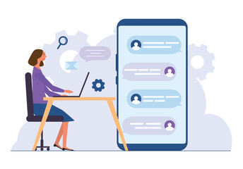 Woman working on laptop at desk with large smartphone showing chat message. Concept of communication.