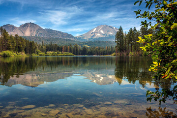 Snow Capped Mount Lassen From Manzanita Lake with Pine Trees and a Reflection