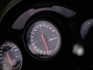 Motorcycle racing dashboard close up speedometer speed rev rpm