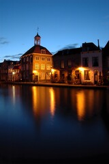 Traditional historical Dutch canal building by night