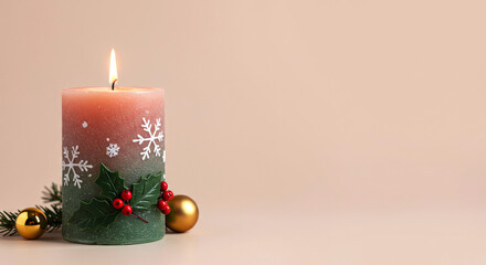 Christmas candle with holly berries and snowflakes on beige background