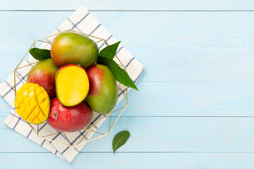 Fresh ripe mango on wooden background, top view