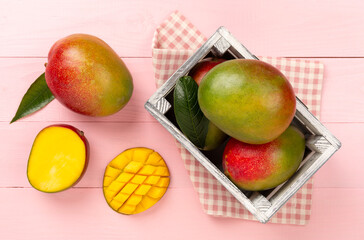 Fresh ripe mango on wooden background, top view