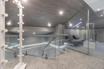 This loft area features elegant lighting, a minimalist design, and a cozy seating space. Large...