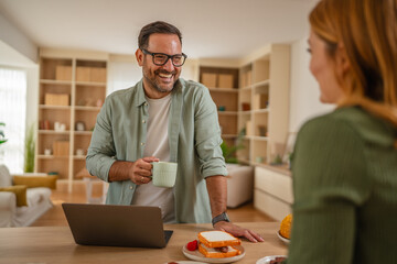 Happy man having conversation with partner during breakfast