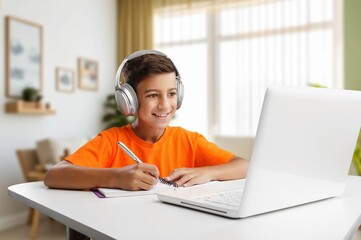 Happy schoolboy student doing homework