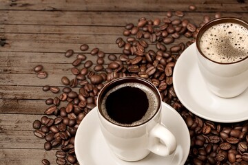 A cup of dark aroma roasted coffee on wooden surface