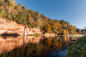 Landscape view of red sandstone cliffs on Gauja river in Sigulda, Latvia at Autumn