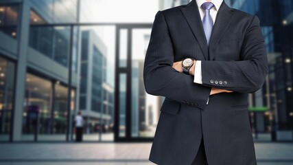 Mature, thinking businessman posing in big city street