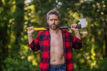 Brutality and masculinity. Hispanic lumberjack man with torso hold axe. Lumberjack axe. Man with logging axe. Hardworking brutal man. Lumberjack hardworking outdoor. Brutal lumberjack