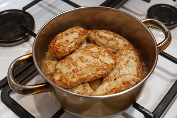 Cooking, stewing meat. Meat patties. Meat cutlets are stewed in saucepan