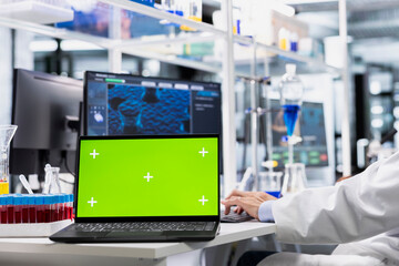 Close up of isolated screen laptop used by lab expert doing genetics study using clinical equipment. Scientist using scientific gear at workbench, doing complex experiments with chroma key notebook