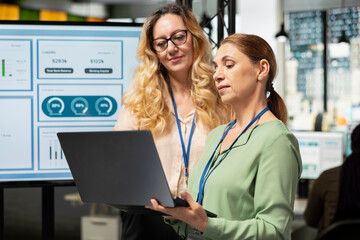 Professional coworkers fixing a strategy and exchanging reports in multinational company, reviewing performance indicators to drive success and professional development. Powerful mindset.