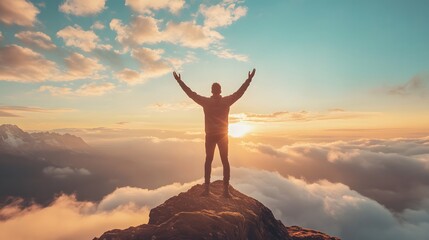 Joyful man celebrating success on mountain peak at sunrise. Arms raised above clouds. Freedom, achievement and confidence in nature. Motivational lifestyle and adventure travel concept