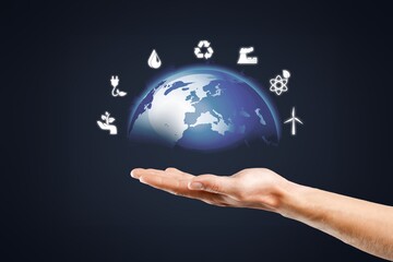 Sustainable development icons and earth on human hand