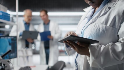 Close up of black woman performing experiments in chemistry and biology. Healthcare technology and...