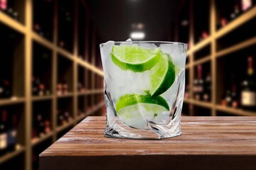 Glass of cold whisky alcohol drink with ice on desk