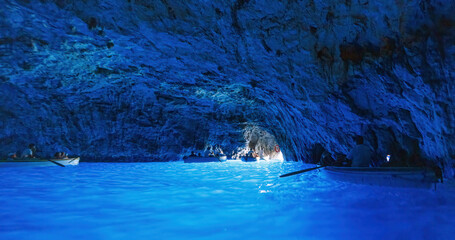 Scenic views of tourists on small boats inside the Blue Grotto on Capri Island, southern Italy