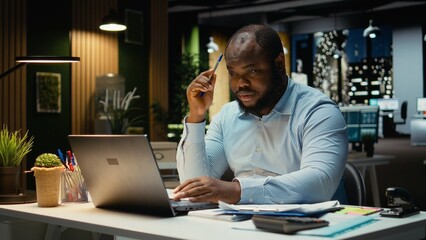 Male analyst contemplating about new investment plan for successful tasks, envisioning new concept to develop the activity. Tactical man planning objectives, searching for solutions.
